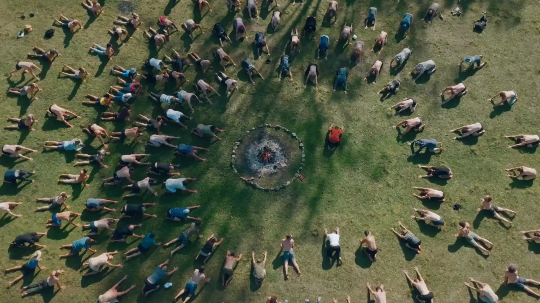 Aerial of 160 men in concentric circles around the central fire at The Gathering of Men